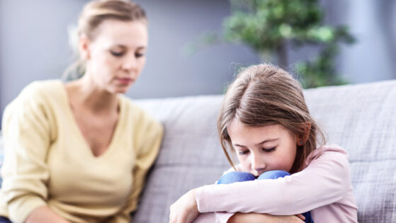 Sad little girl and her mom at home